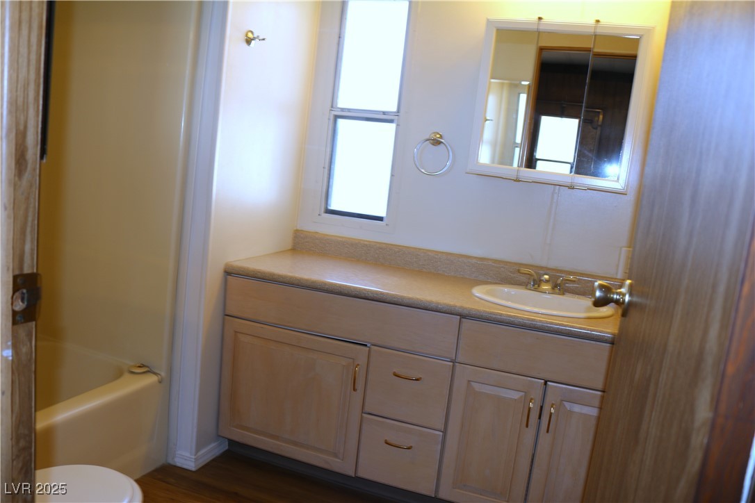 4633 Royal Ridge Boulevard Las Vegas, NV 89103 - Photo 7 of 13 Full bath with toilet and vanity