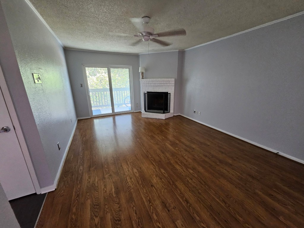 1505 Ward Road, Unit 112 Baytown, TX 77520 - Photo 12 of 15 wooden floor in an empty room with a fireplace