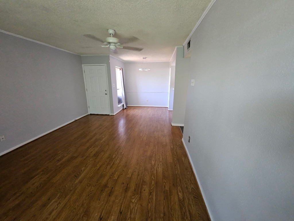 1505 Ward Road, Unit 112 Baytown, TX 77520 - Photo 9 of 15 an empty room with wooden floor and a ceiling fan