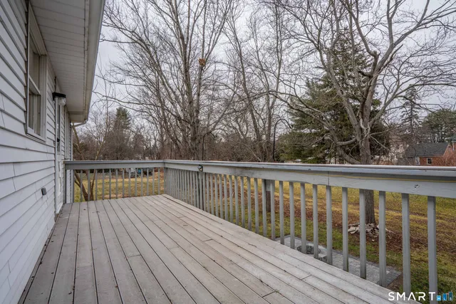a view of balcony with wooden floor and fence