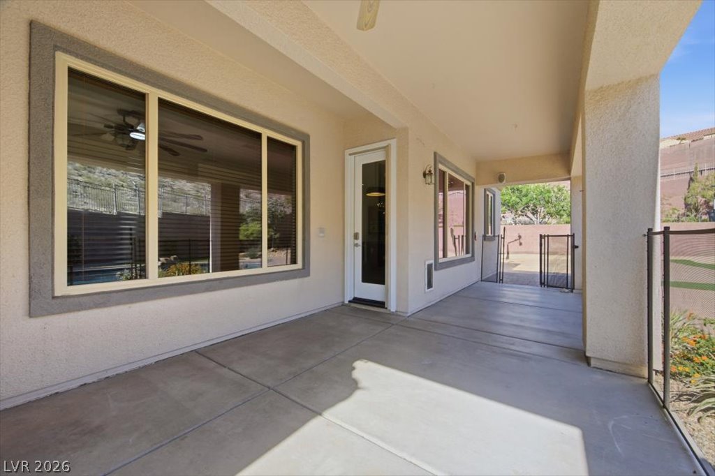 2125 De Rouge Avenue Henderson, NV 89044 - Photo 70 of 96 A spacious covered patio offers a refreshing outdoor retreat with direct access to the yard.