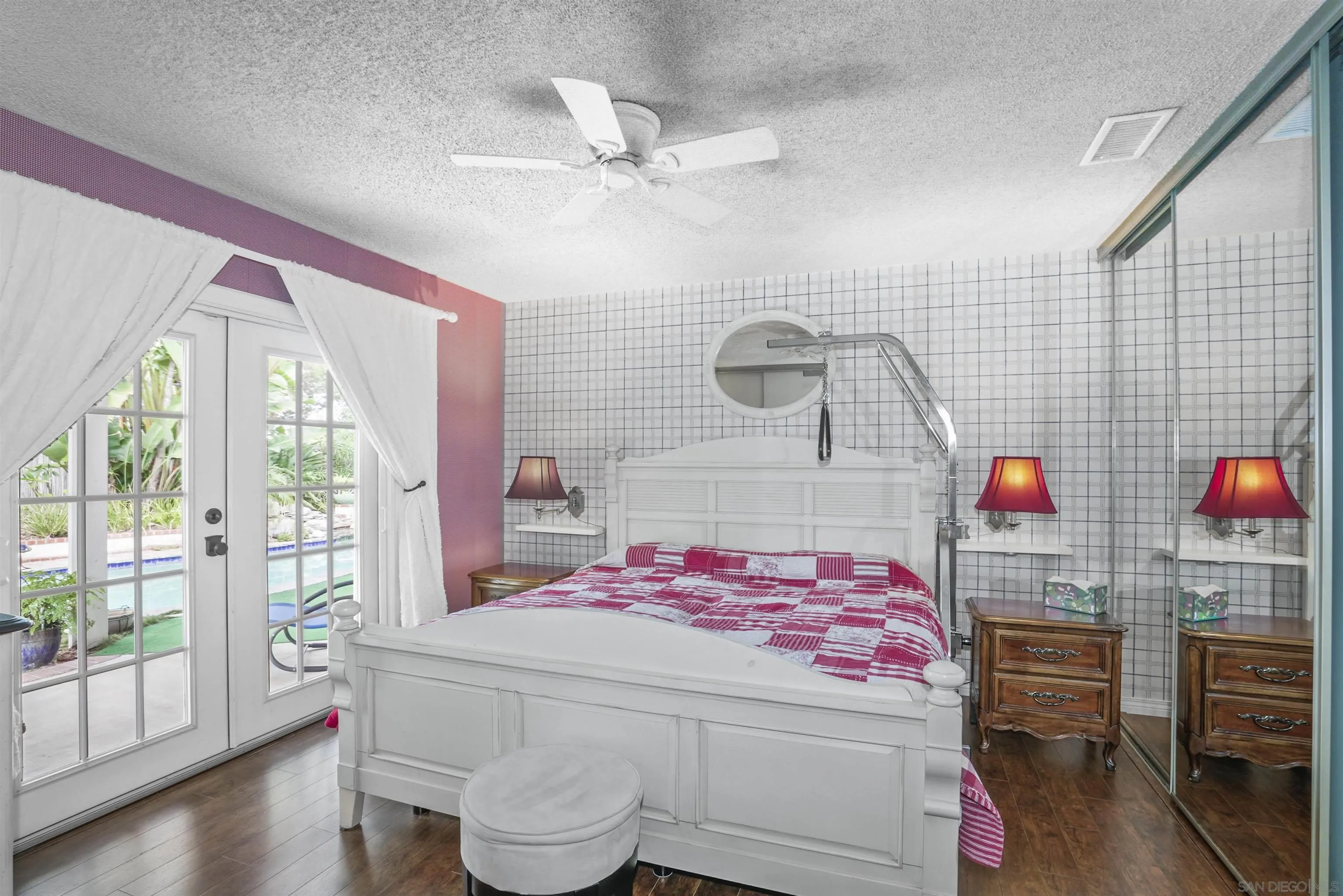 4660 Lofty Grove Drive Oceanside, CA 92056 - Photo 13 of 22 a bedroom with a bed and a chandelier