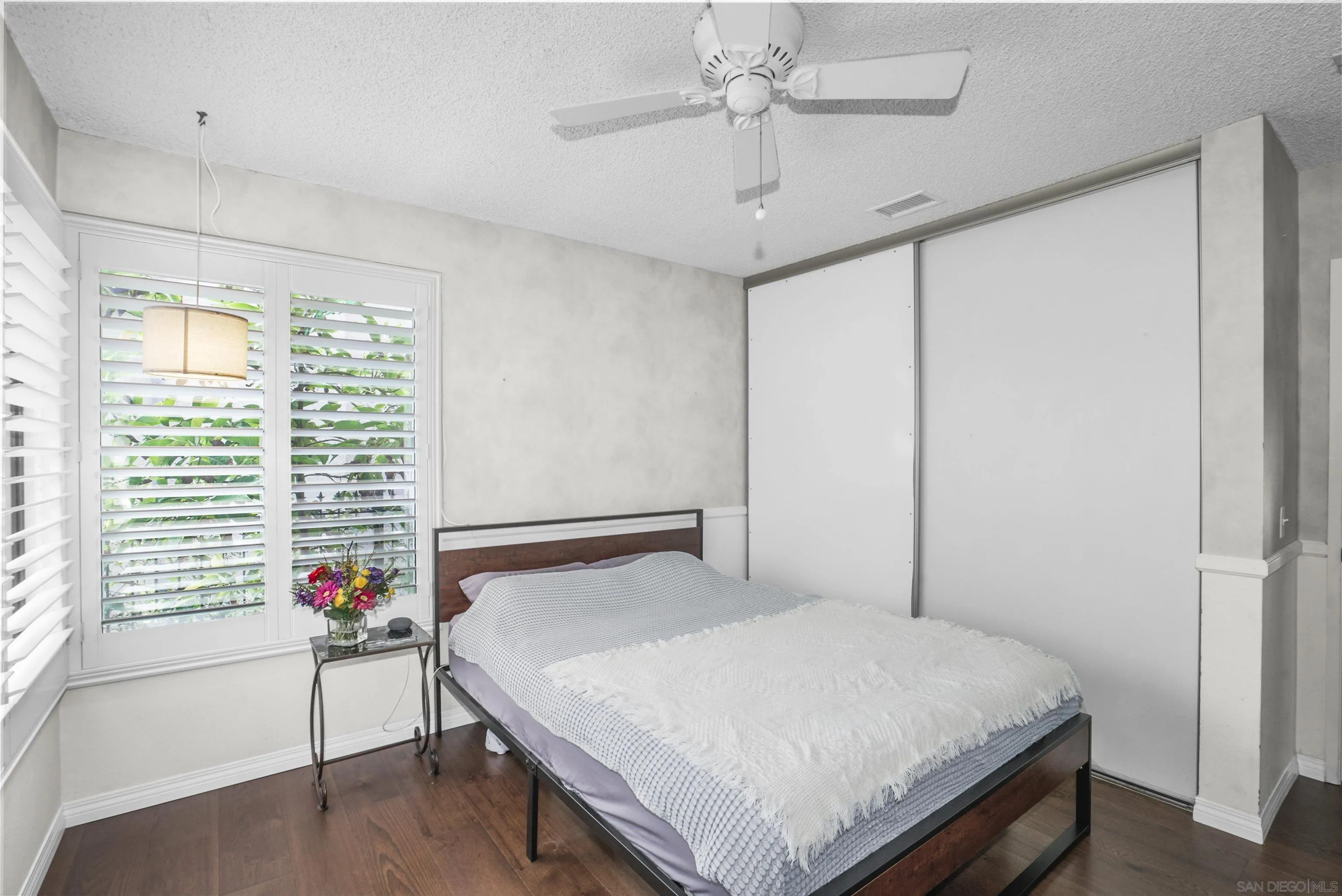 4660 Lofty Grove Drive Oceanside, CA 92056 - Photo 16 of 22 a bedroom with a bed and a chandelier