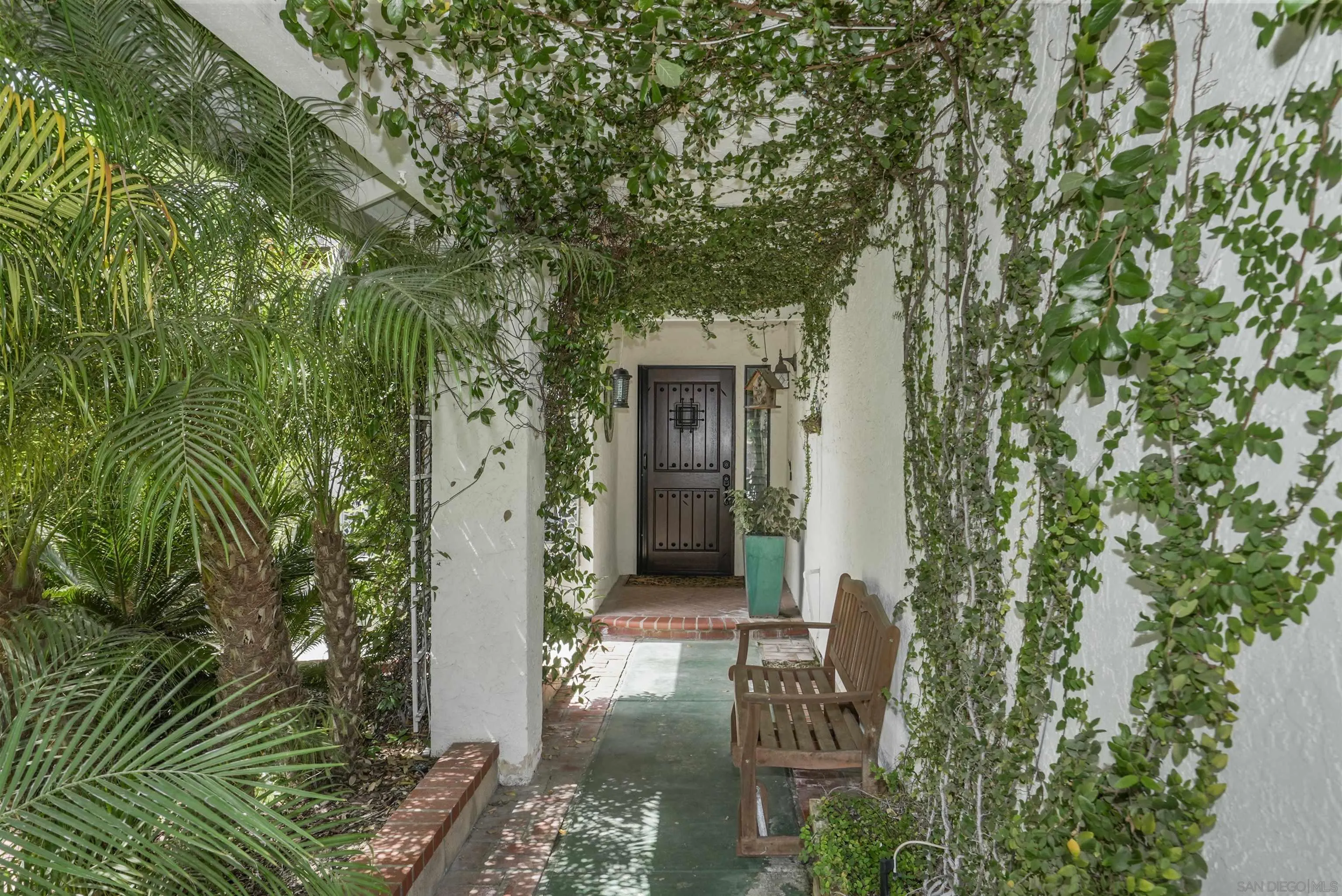 4660 Lofty Grove Drive Oceanside, CA 92056 - Photo 2 of 22 a front view of a house with a tree