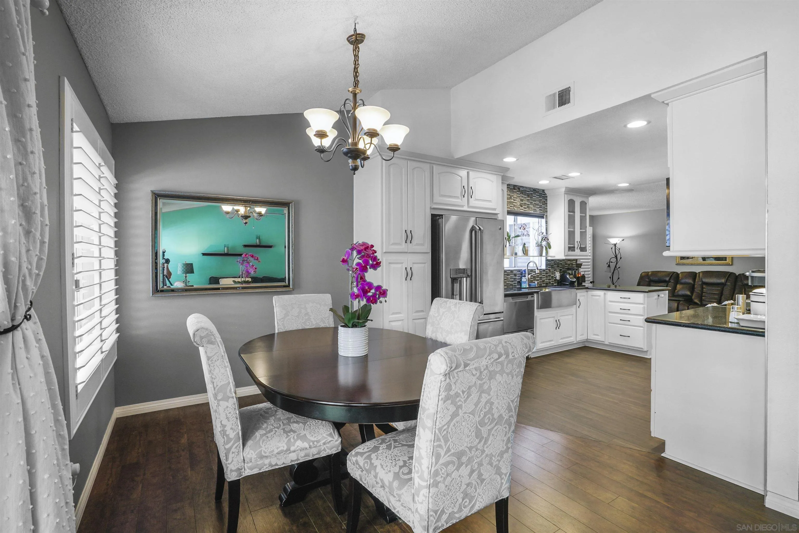 4660 Lofty Grove Drive Oceanside, CA 92056 - Photo 8 of 22 a view of a dining room with furniture and a chandelier