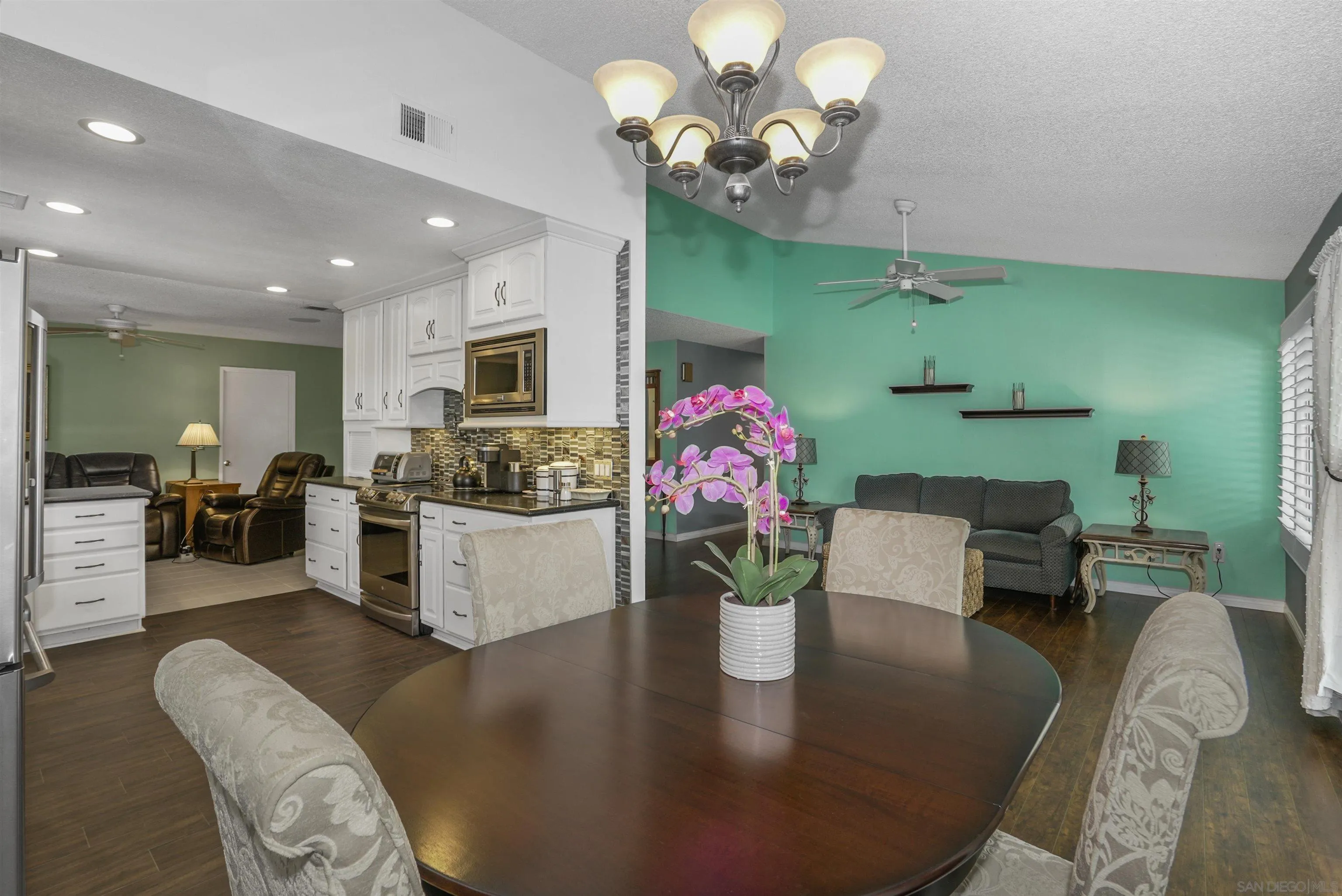 4660 Lofty Grove Drive Oceanside, CA 92056 - Photo 9 of 22 a living room with furniture chandelier and kitchen view