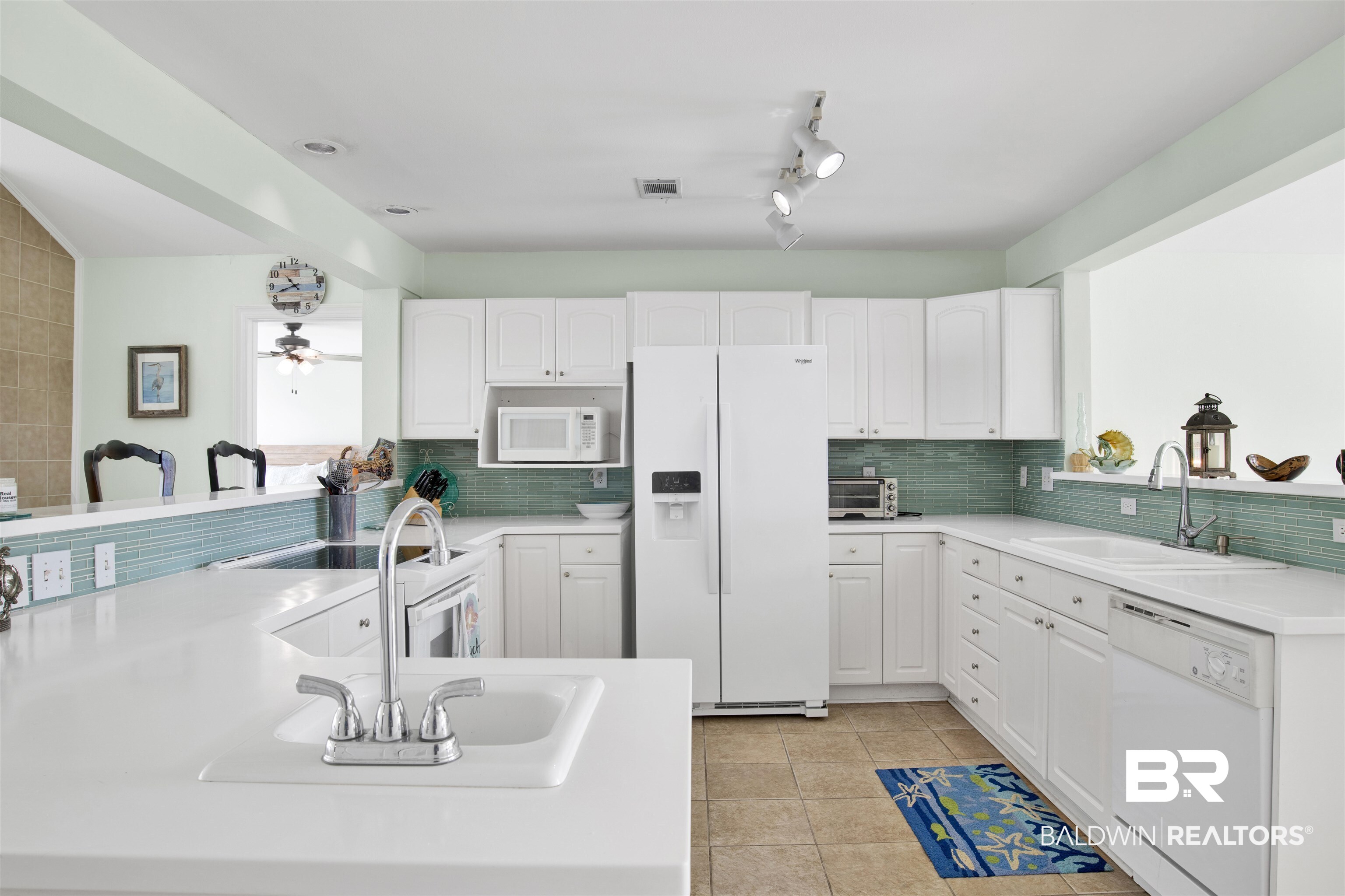 33093 River Road Orange Beach, AL 36561 - Photo 8 of 30 Kitchen featuring white cabinetry, tasteful backsplash, white appliances, ceiling fan, and sink