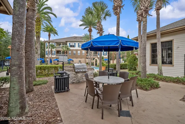 a living room with furniture ceiling fan and a chandelier