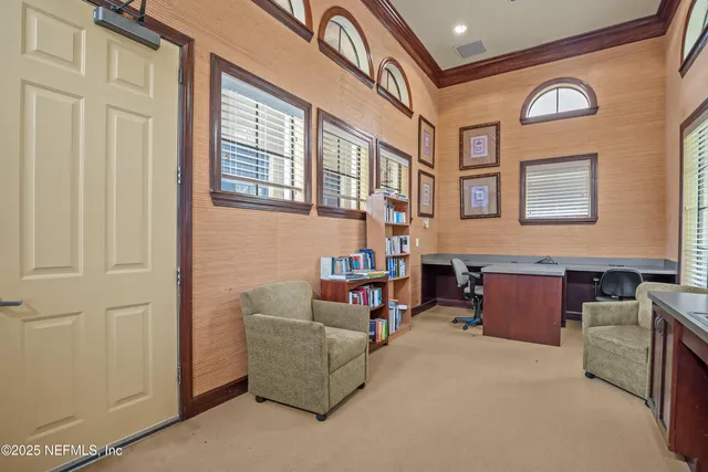 a living room with furniture chandelier and a large window