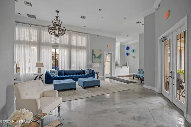 a living room with furniture and a chandelier
