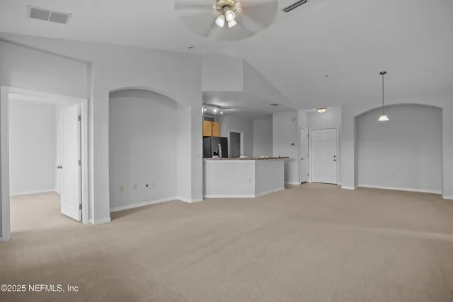 a kitchen with stainless steel appliances granite countertop a refrigerator a stove a sink and a microwave