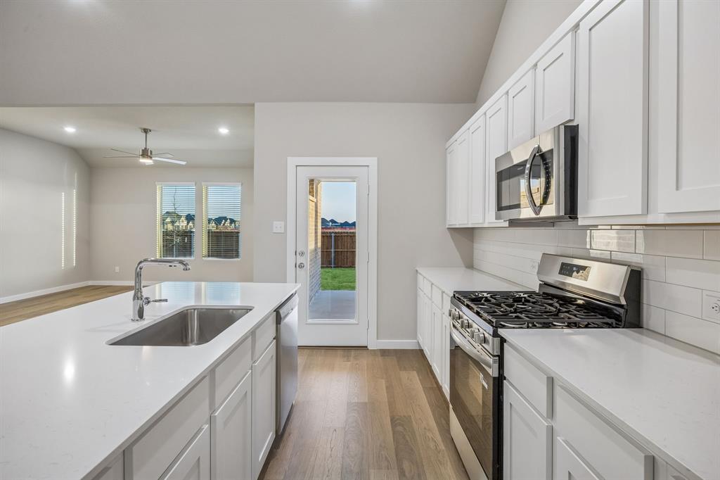 1404 Companero Street Haslet, TX 76052 - Photo 8 of 40 Kitchen in the Wimbledon home plan by Trophy Signature Homes – REPRESENTATIVE PHOTO