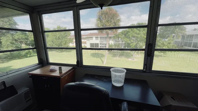 a view of a dining room with furniture and window