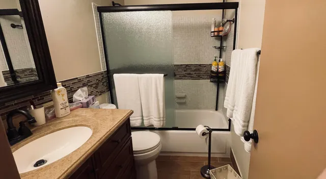 a kitchen with stainless steel appliances granite countertop a stove a refrigerator a sink dishwasher and cabinets with wooden floor