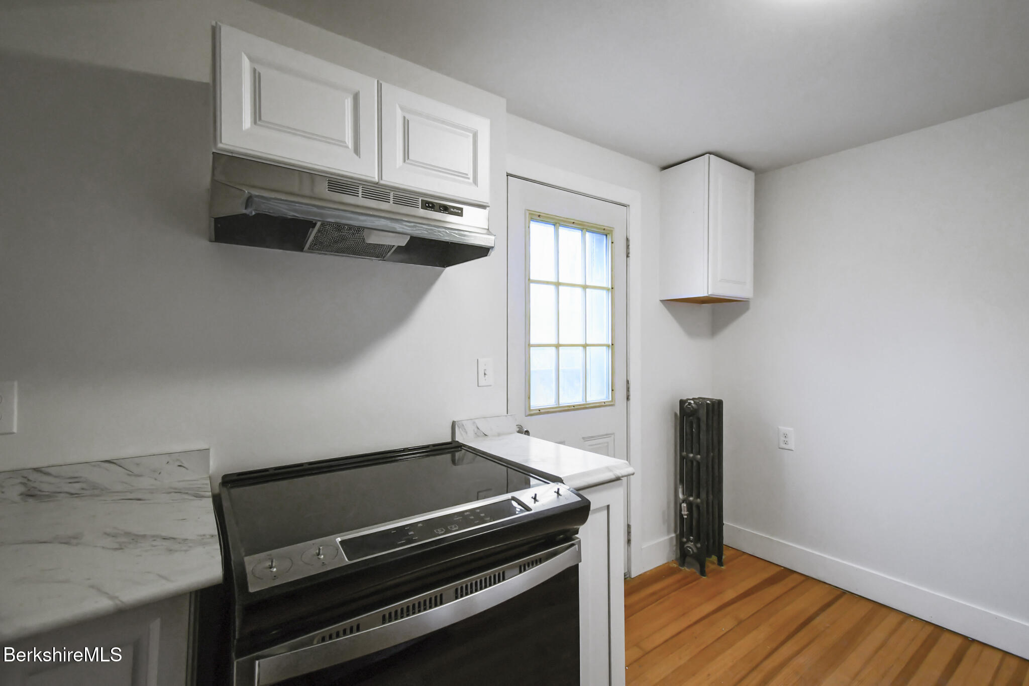 111 Columbia Street Adams, MA 01220 - Photo 11 of 33 a kitchen with wooden cabinets and a stove top oven