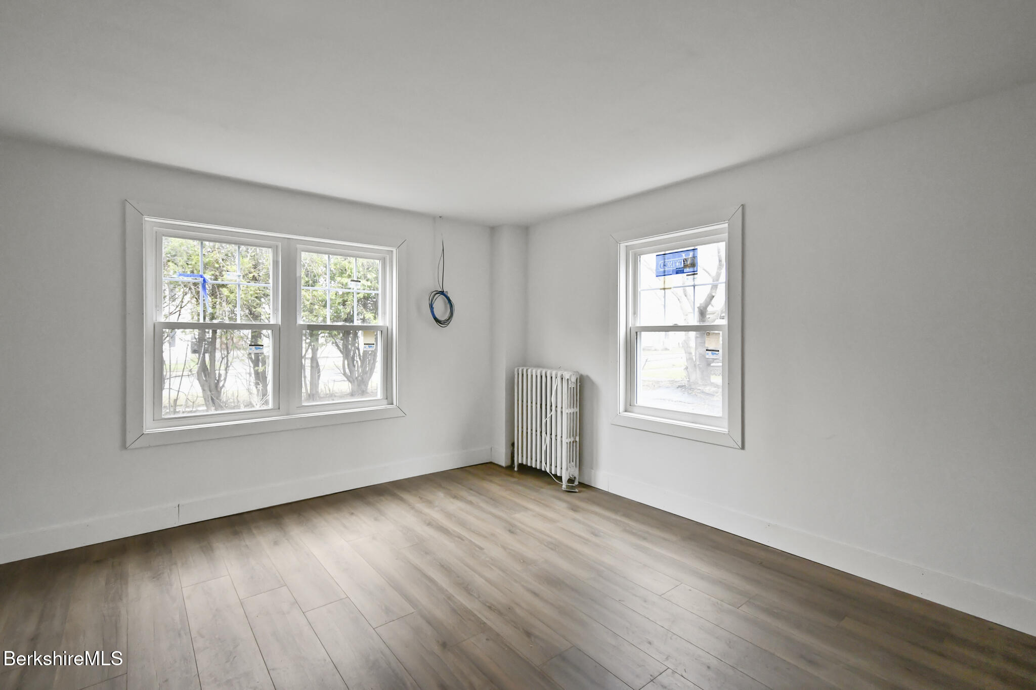 111 Columbia Street Adams, MA 01220 - Photo 20 of 33 a view of an empty room with wooden floor and a window
