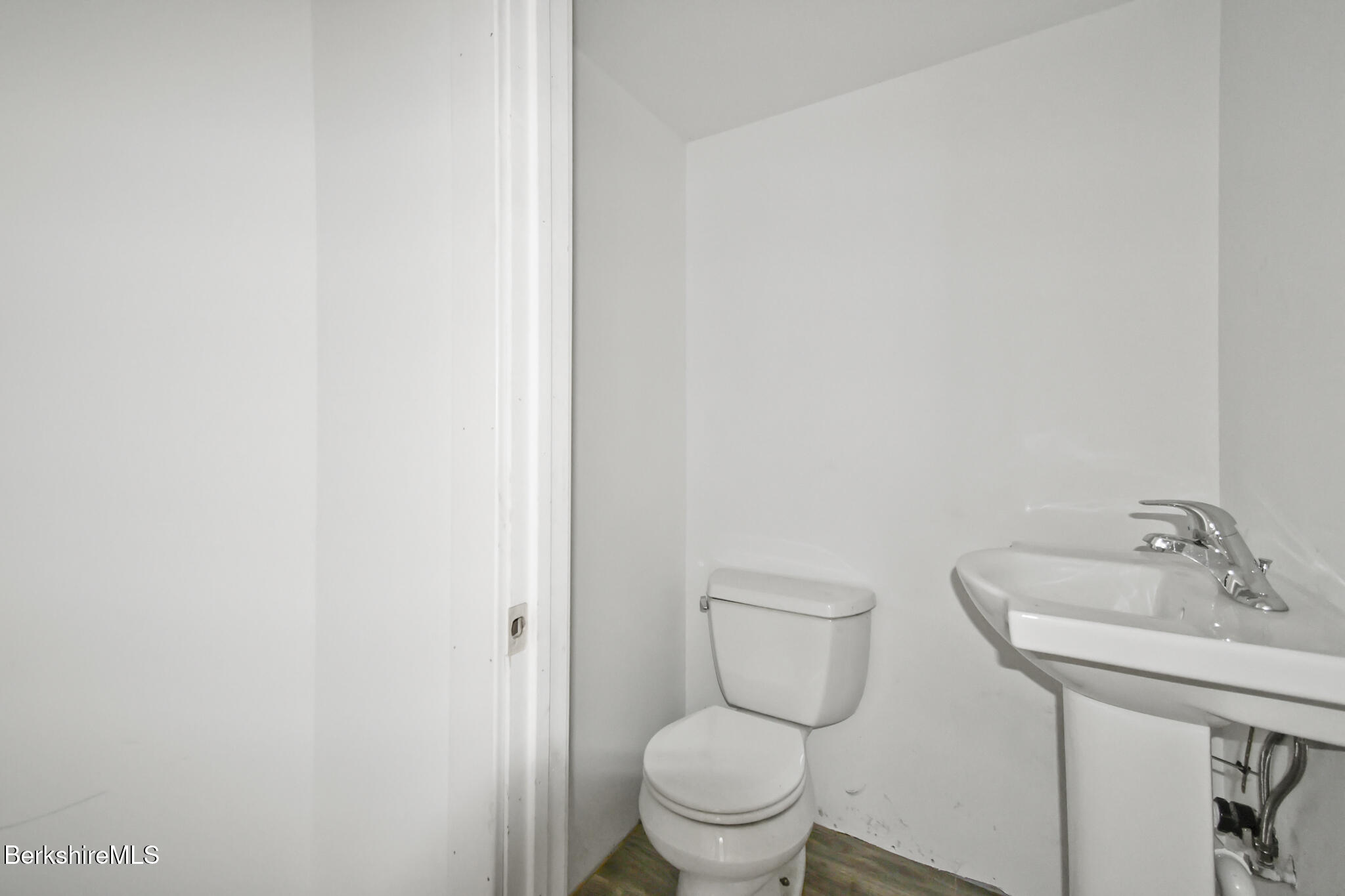 111 Columbia Street Adams, MA 01220 - Photo 21 of 33 a white toilet sitting next to a bathroom sink