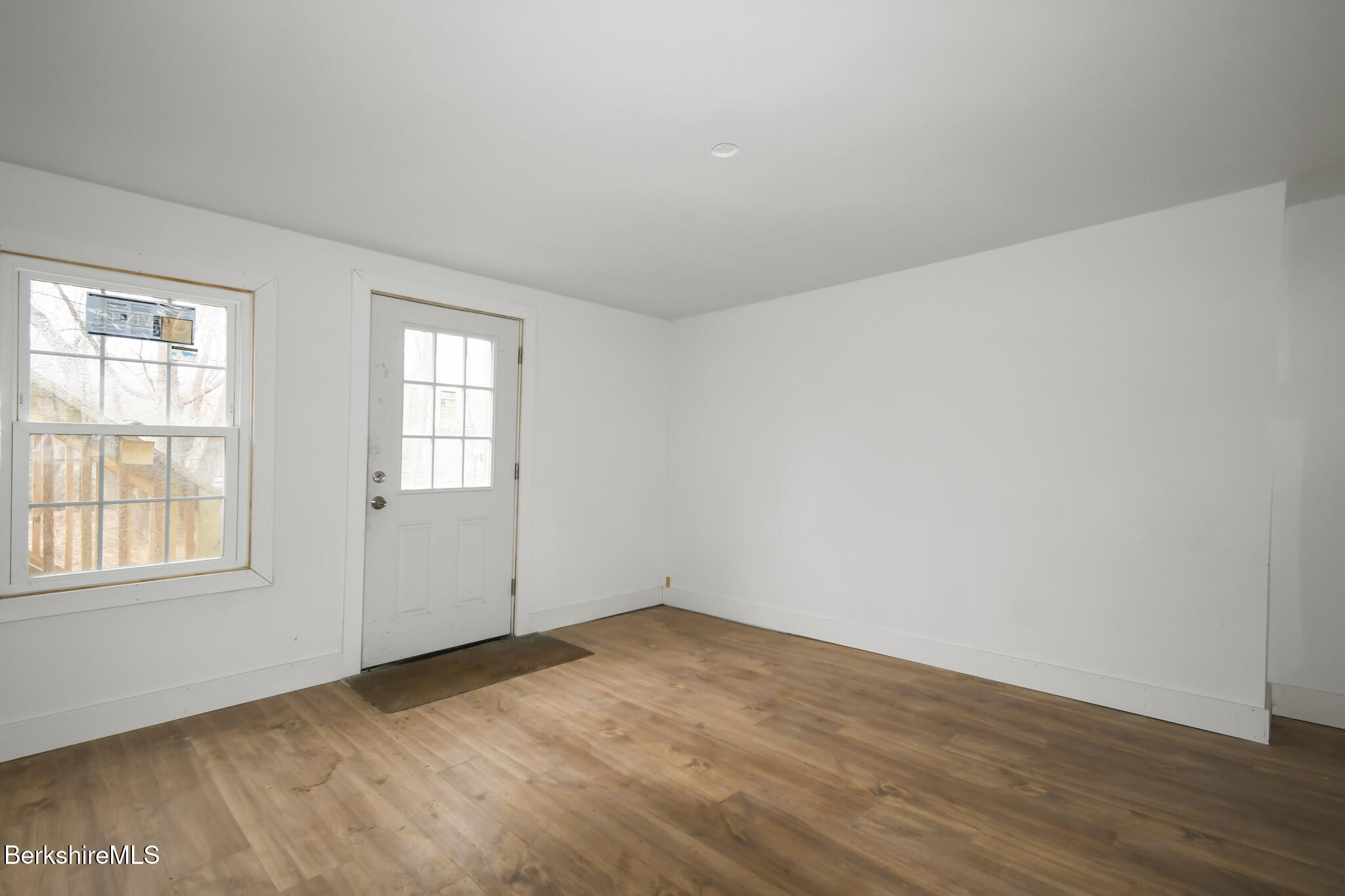111 Columbia Street Adams, MA 01220 - Photo 29 of 33 an empty room with wooden floor and windows