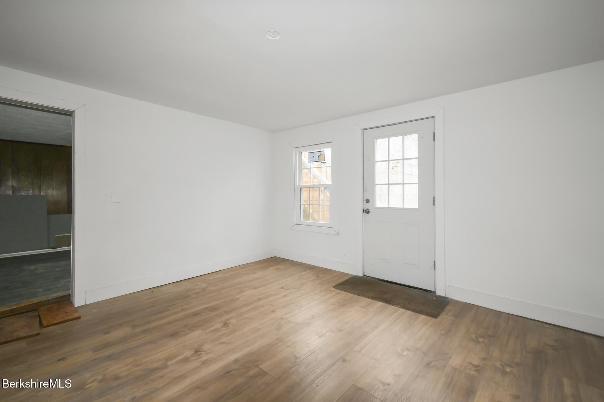 111 Columbia Street Adams, MA 01220 - Photo 30 of 33 an empty room with wooden floor cabinet and windows