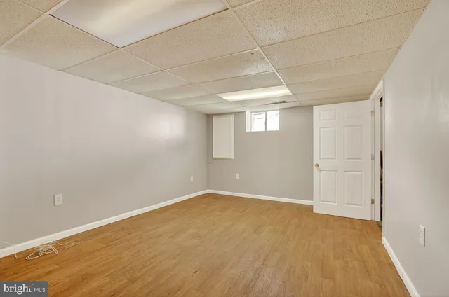 a view of a room with wooden floor and white walls