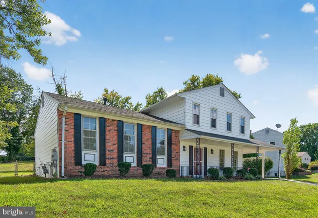 a large brick building with a yard in front of it