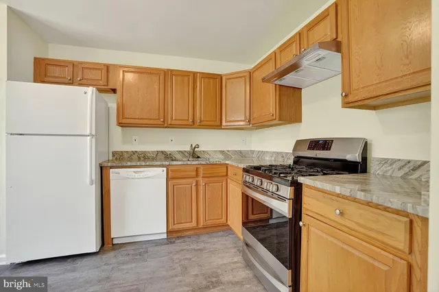 a kitchen with a sink stove and refrigerator