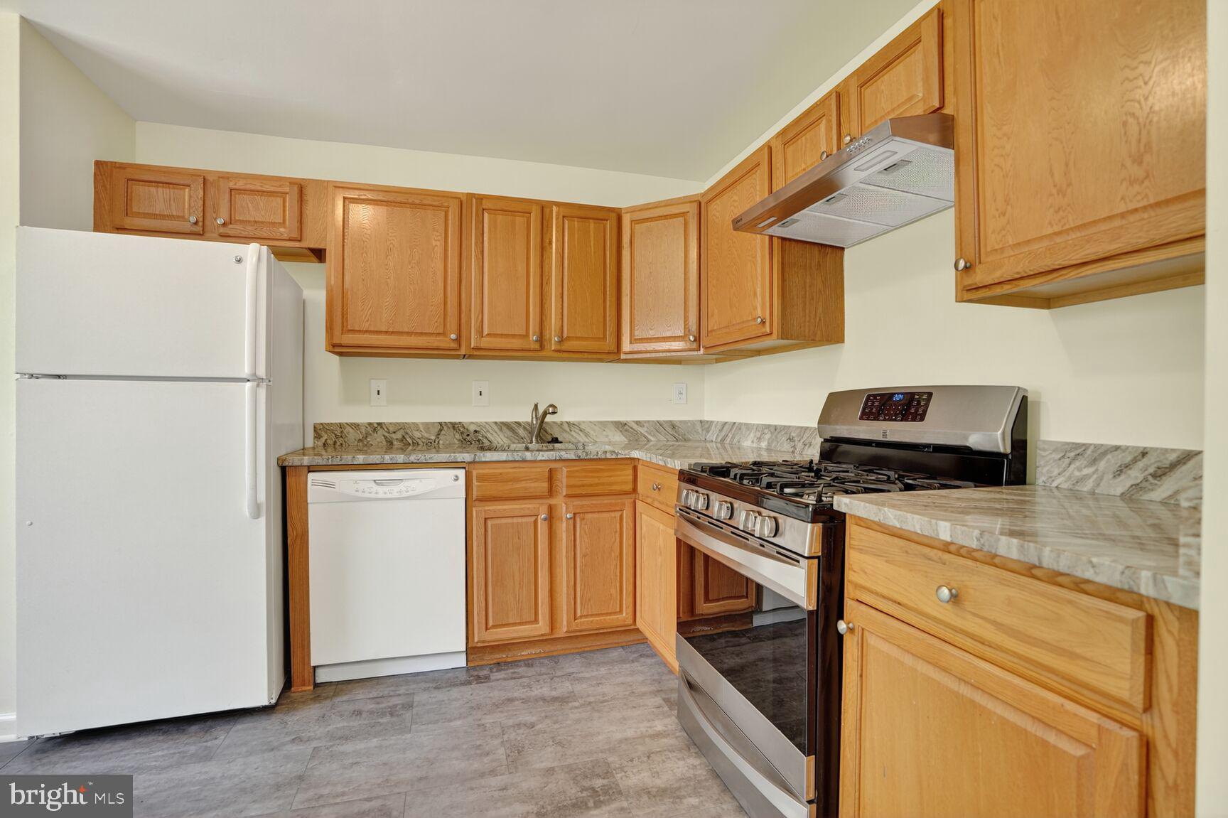 7720 Loudon Drive Fort Washington, MD 20744 - Photo 7 of 28 a kitchen with a sink stove and refrigerator
