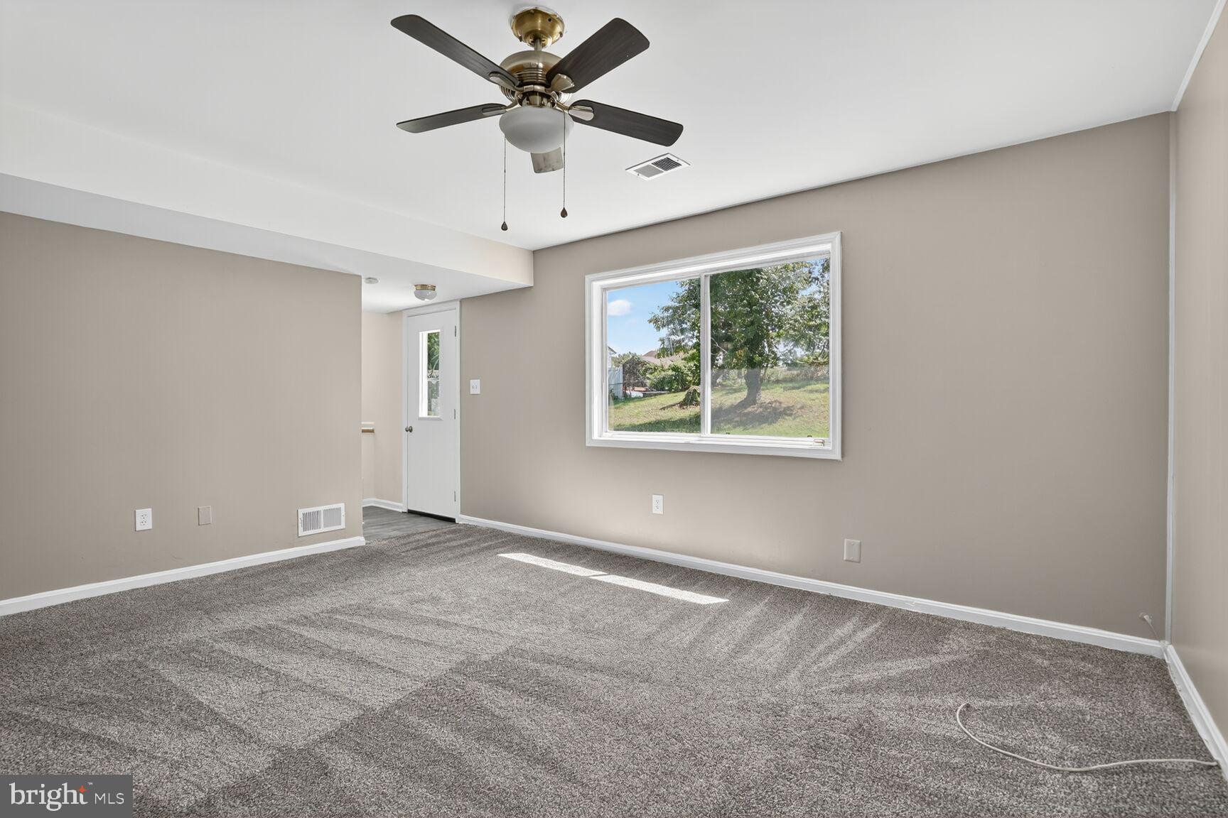 7720 Loudon Drive Fort Washington, MD 20744 - Photo 9 of 28 an empty room with ceiling fan and windows