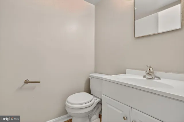 a bathroom with a sink a toilet and mirror