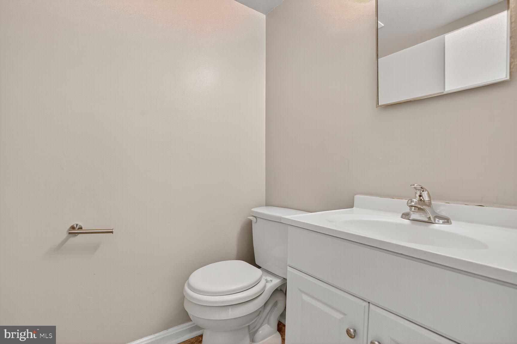 7720 Loudon Drive Fort Washington, MD 20744 - Photo 10 of 28 a bathroom with a sink a toilet and mirror