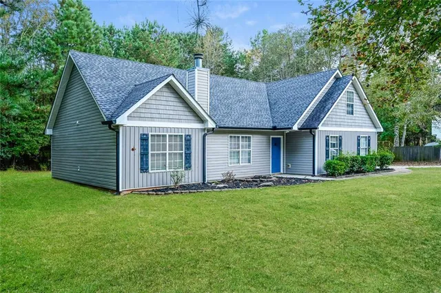 a view of an empty room with a window and fireplace