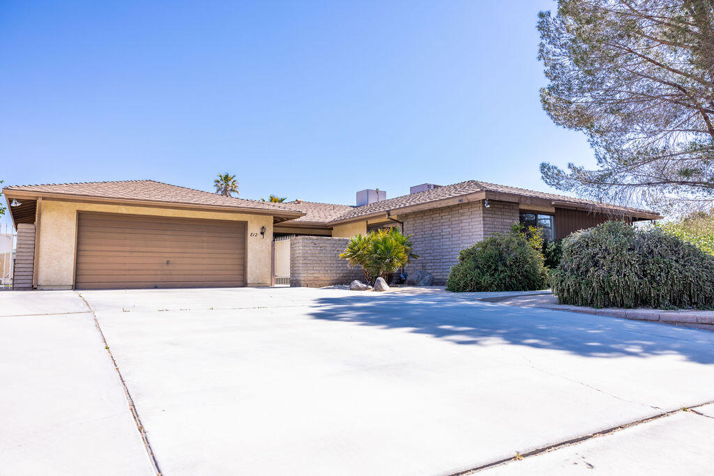 812 West Vicki Avenue Ridgecrest, CA 93555 - Photo 1 of 68 a front view of a house with a yard and garage