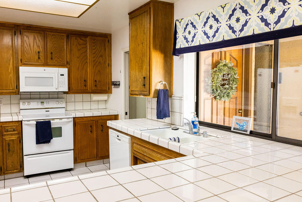 812 West Vicki Avenue Ridgecrest, CA 93555 - Photo 41 of 68 a kitchen with stainless steel appliances granite countertop a stove a sink and a microwave