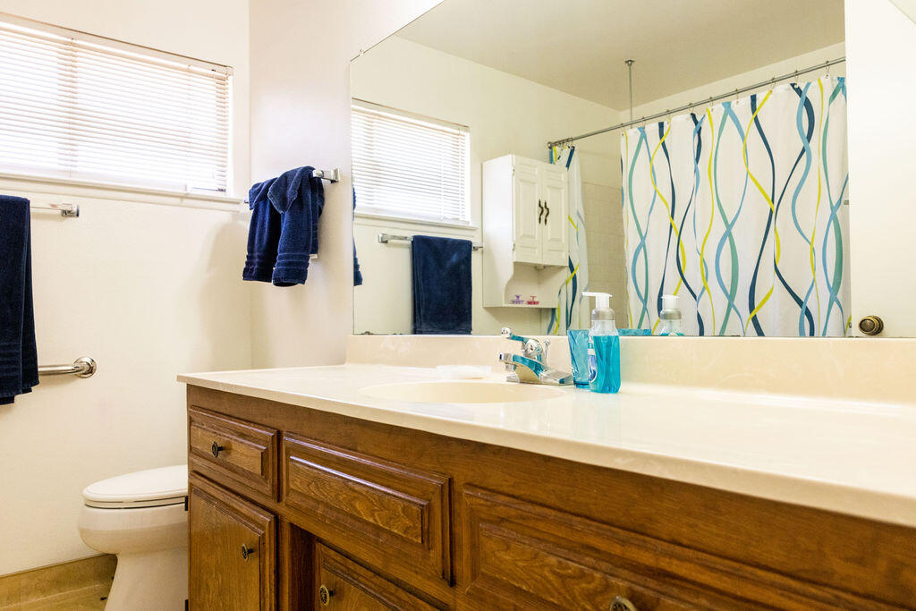 812 West Vicki Avenue Ridgecrest, CA 93555 - Photo 54 of 68 a bathroom with a sink a toilet and a mirror