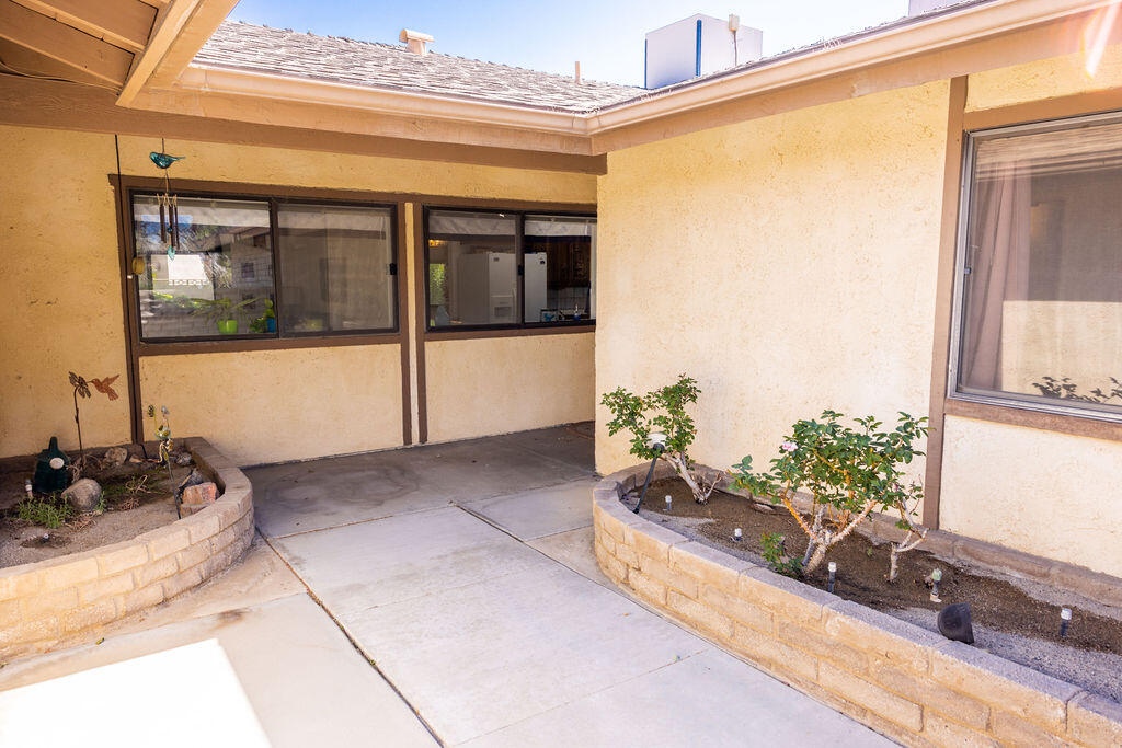 812 West Vicki Avenue Ridgecrest, CA 93555 - Photo 61 of 68 a potted plant sitting on a window sill and a floor to ceiling window