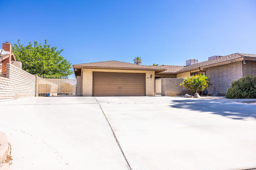 812 West Vicki Avenue Ridgecrest, CA 93555 - Photo 65 of 68 a front view of a house with a yard and garage