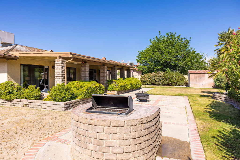 812 West Vicki Avenue Ridgecrest, CA 93555 - Photo 8 of 68 a view of a white house with a yard and potted plants