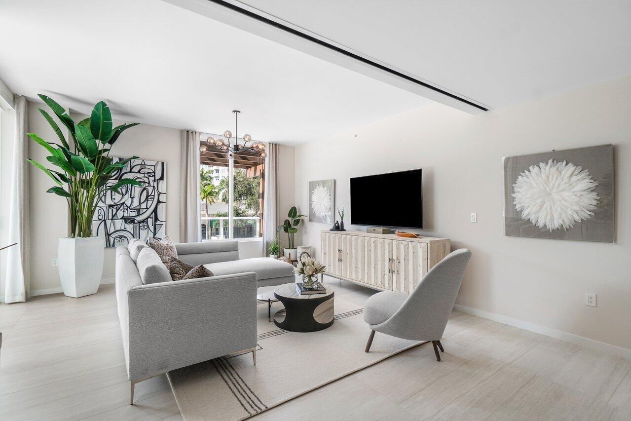 200 Southeast Mizner Boulevard, Unit 211 Boca Raton, FL 33432 - Photo 11 of 67 a living room with furniture potted plant and a flat screen tv