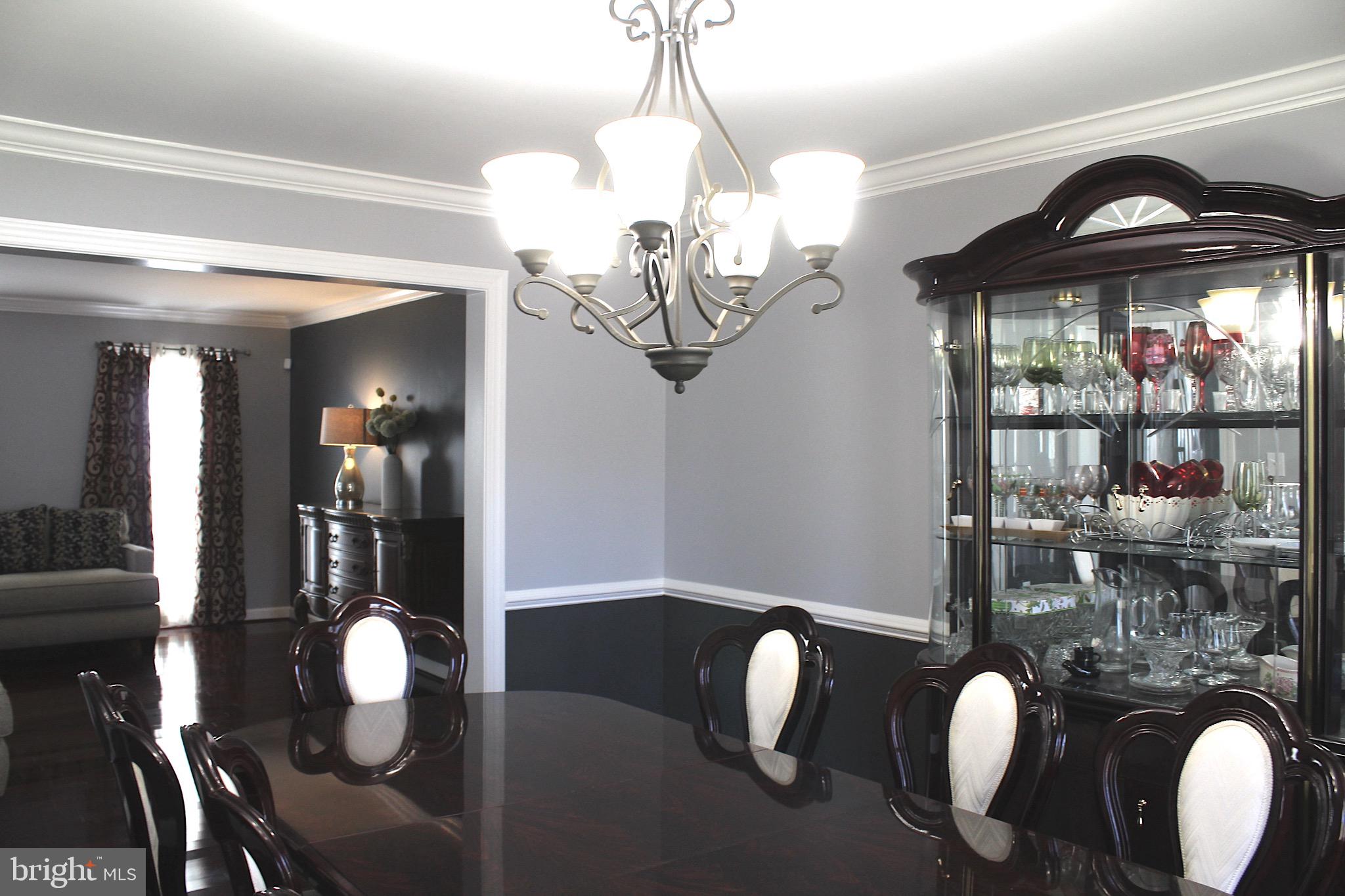 11546 Waesche Drive Bowie, MD 20721 - Photo 12 of 21 a view of a dining room with furniture wooden floor and chandelier