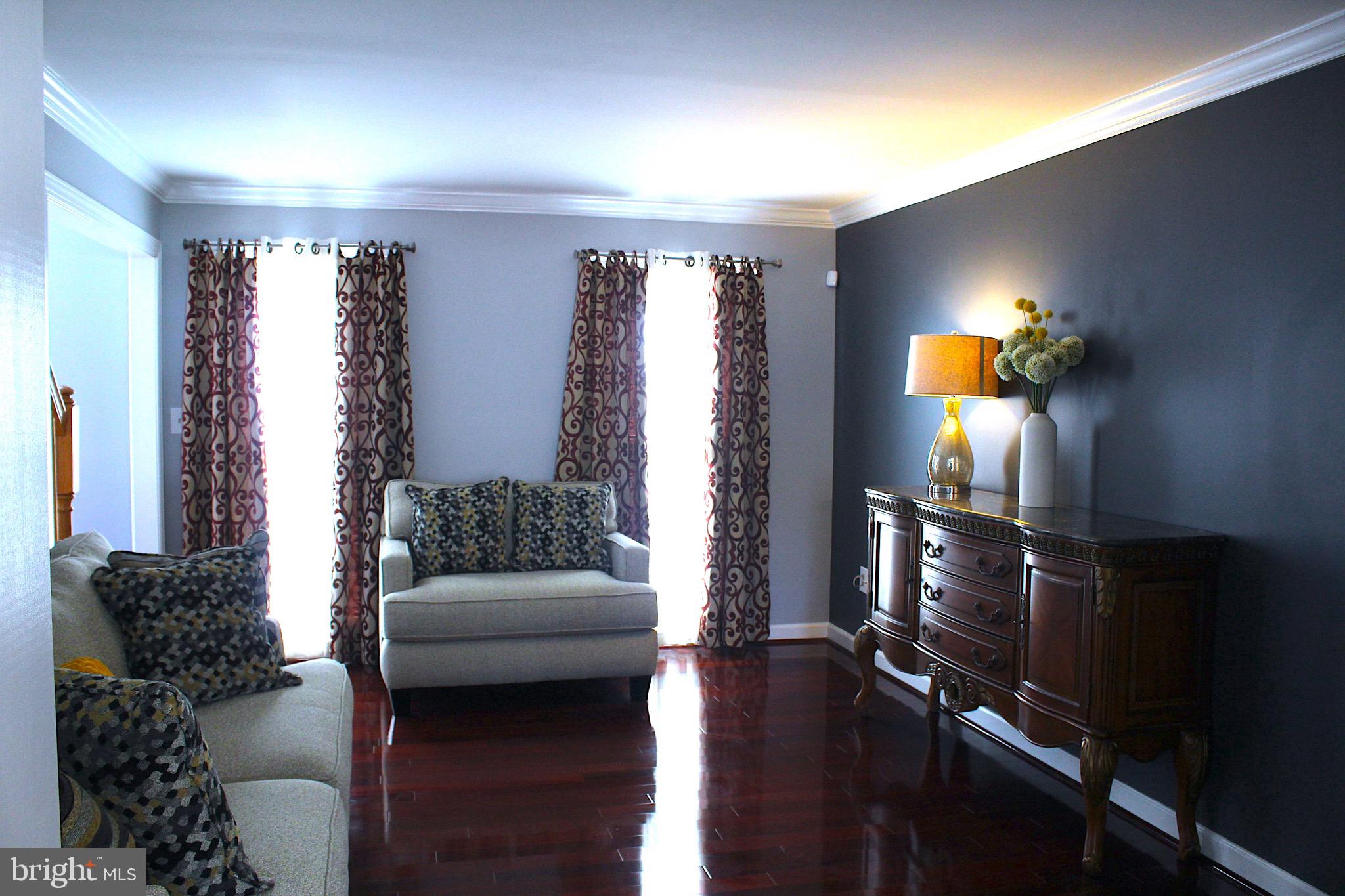 11546 Waesche Drive Bowie, MD 20721 - Photo 13 of 21 a living room with furniture and a chandelier