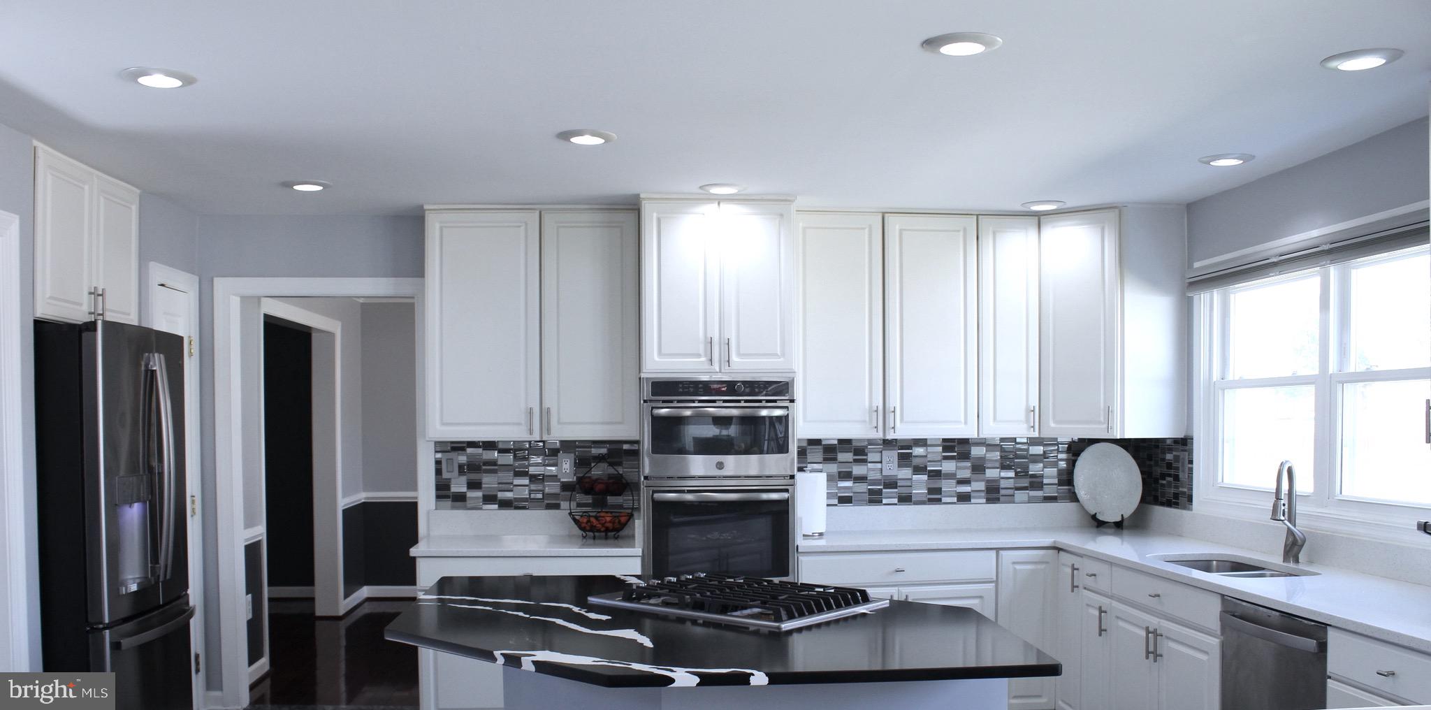 11546 Waesche Drive Bowie, MD 20721 - Photo 4 of 21 a kitchen with stainless steel appliances granite countertop a stove and a refrigerator