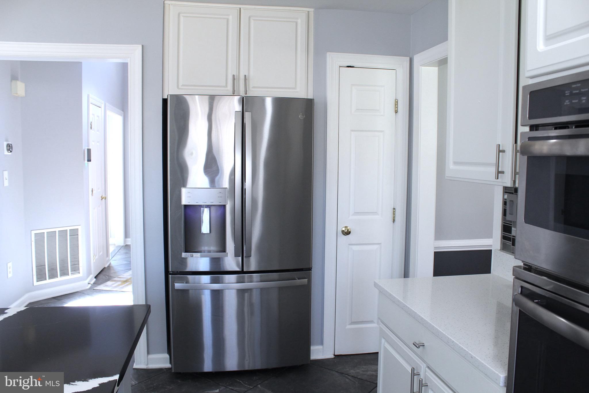 11546 Waesche Drive Bowie, MD 20721 - Photo 7 of 21 a kitchen with stainless steel appliances a refrigerator a stove a sink and a window
