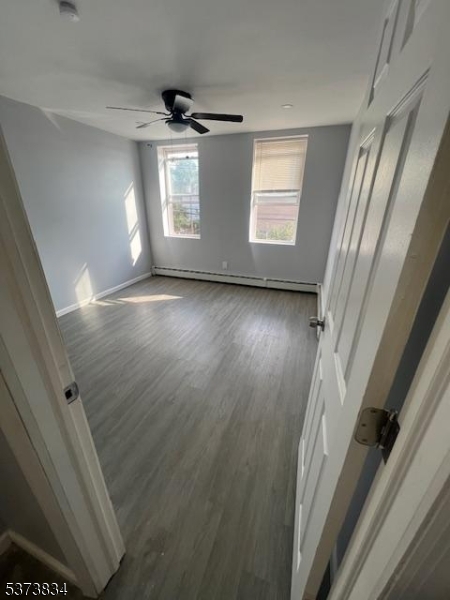 21 Alva Street Bloomfield, NJ 07003 - Photo 11 of 14 a view of a livingroom with wooden floor and window