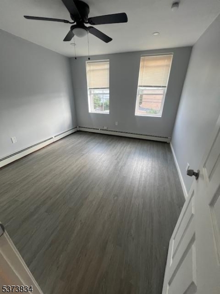21 Alva Street Bloomfield, NJ 07003 - Photo 14 of 14 an empty room with wooden floor fan and windows