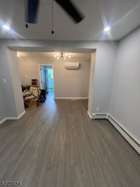 21 Alva Street Bloomfield, NJ 07003 - Photo 3 of 14 an empty room with wooden floor and windows