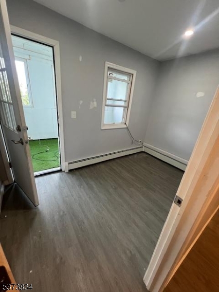 21 Alva Street Bloomfield, NJ 07003 - Photo 5 of 14 an empty room with wooden floor and windows