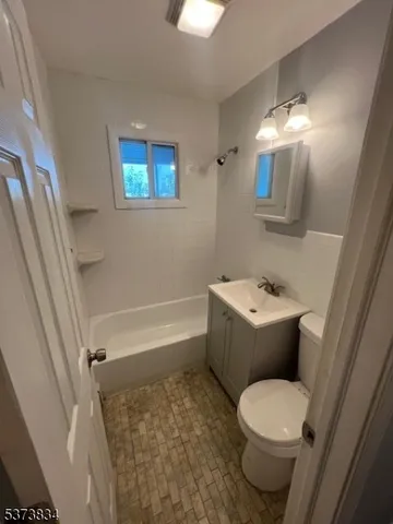 a white toilet sitting next to a bathroom sink