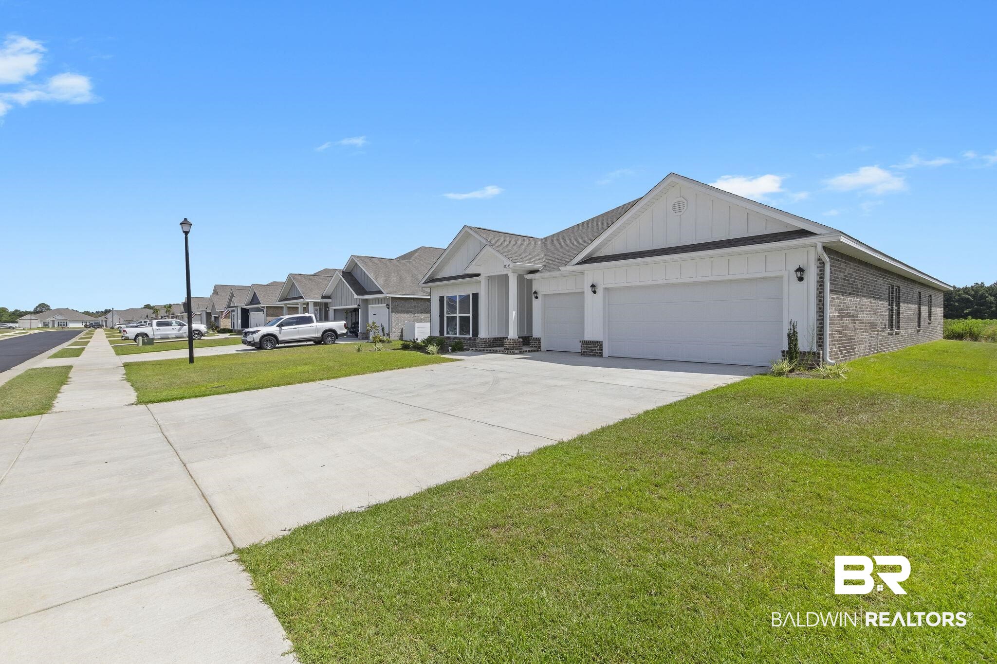 11303 Genuine Risk Circle Daphne, AL 36526 - Photo 5 of 100 Ranch-style house with a front lawn and a garage