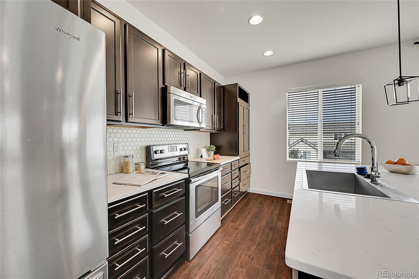 10951 Touchstone Loop Parker, CO 80134 - Photo 16 of 46 a kitchen with stainless steel appliances a sink stove and refrigerator