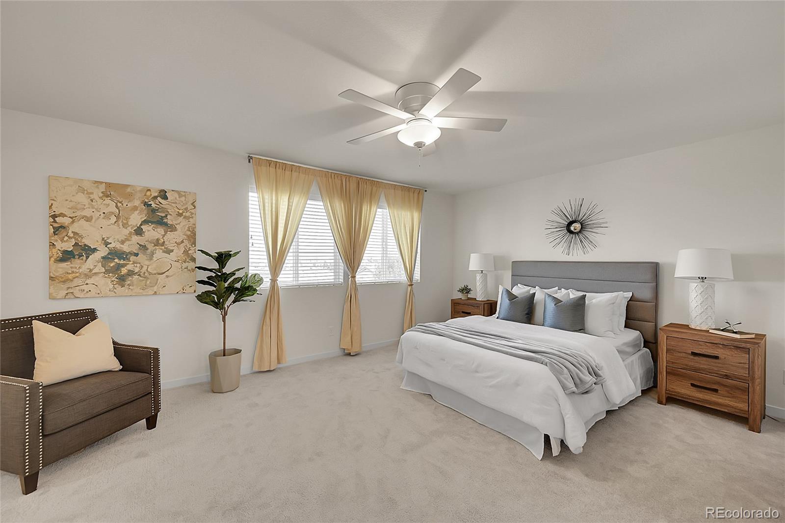 10951 Touchstone Loop Parker, CO 80134 - Photo 19 of 46 a spacious bedroom with a bed and a chandelier